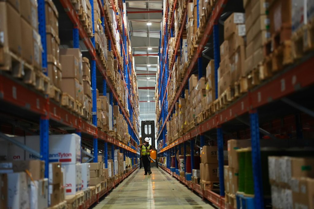 Rows of shelves filled with boxes in a warehouse.